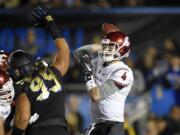 Washington State quarterback Luke Falk, right, passes under pressure from UCLA defensive lineman Matt Dickerson during the first half of an NCAA college football game, Saturday, Nov. 14, 2015, in Pasadena, Calif. (AP Photo/Mark J.