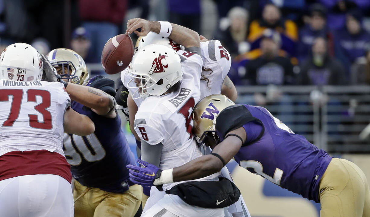 Washington&#039;s Cory Littleton, right, dislodges the ball from Washington State quarterback Peyton Bender (6) during the second half Friday.