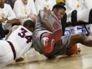 Arizona State guard Jermaine Marshall, left, and Washington State forward Junior Longrus scramble for the ball during the first half Sunday at Tempe, Ariz.