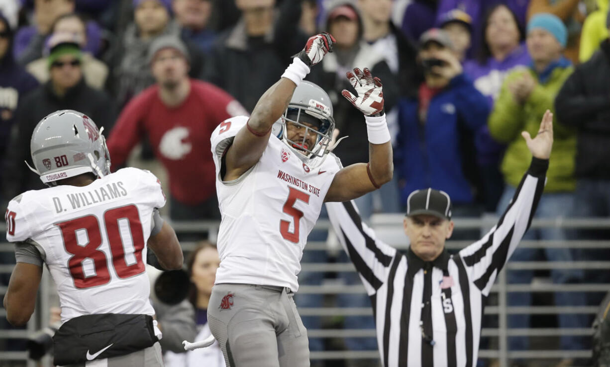 Washington State's Rickey Galvin (5) celebrates his 14-yard touchdown reception with Dom Williams as official Bernie Hulscher signals the score in the first half Friday.