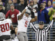 Washington State's Rickey Galvin (5) celebrates his 14-yard touchdown reception with Dom Williams as official Bernie Hulscher signals the score in the first half Friday.