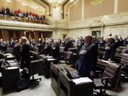 Members of the House recite the pledge of allegiance Monday on the first day of the 2014 session of the Washington state Legislature at the Capitol in Olympia.