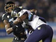 UCLA safety Brandon Sermons, left, stops Washington wide receiver Damore'ea Stringfellow (9) during the second quarter of an NCAA college football game Friday, Nov. 15, 2013, in Pasadena, Calif.