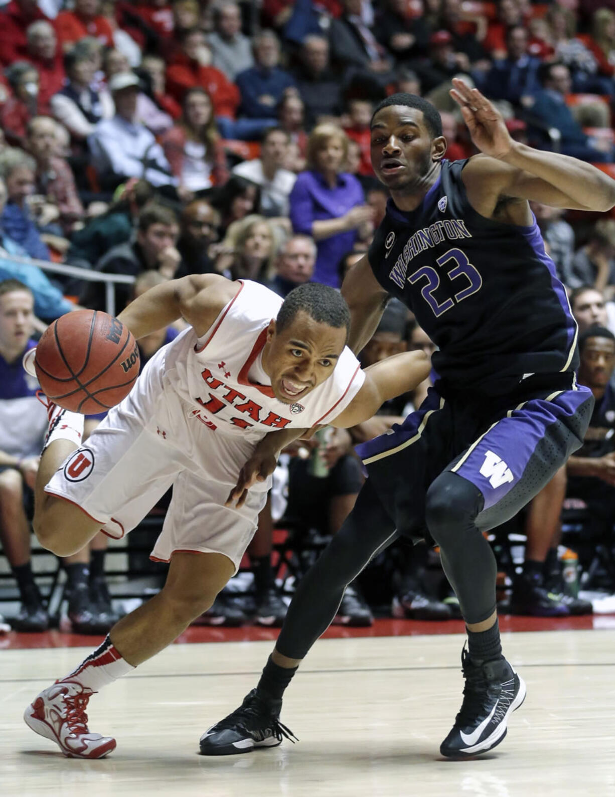 Utah's Brandon Taylor, left, drives past Washington's C.J.