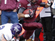 Montana wide receiver Ellis Henderson (7) runs past a Weber State defensive back after catching a pass in the third quarter of an NCAA college football game in Missoula, Mont., Saturday, Nov. 16, 2013.