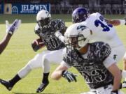 Weber State's Karl Finai (33) defends against Portland State's DJ Adams (10) during the first half of an NCAA college football game in Portland, Ore., Saturday Nov 2, 2013.