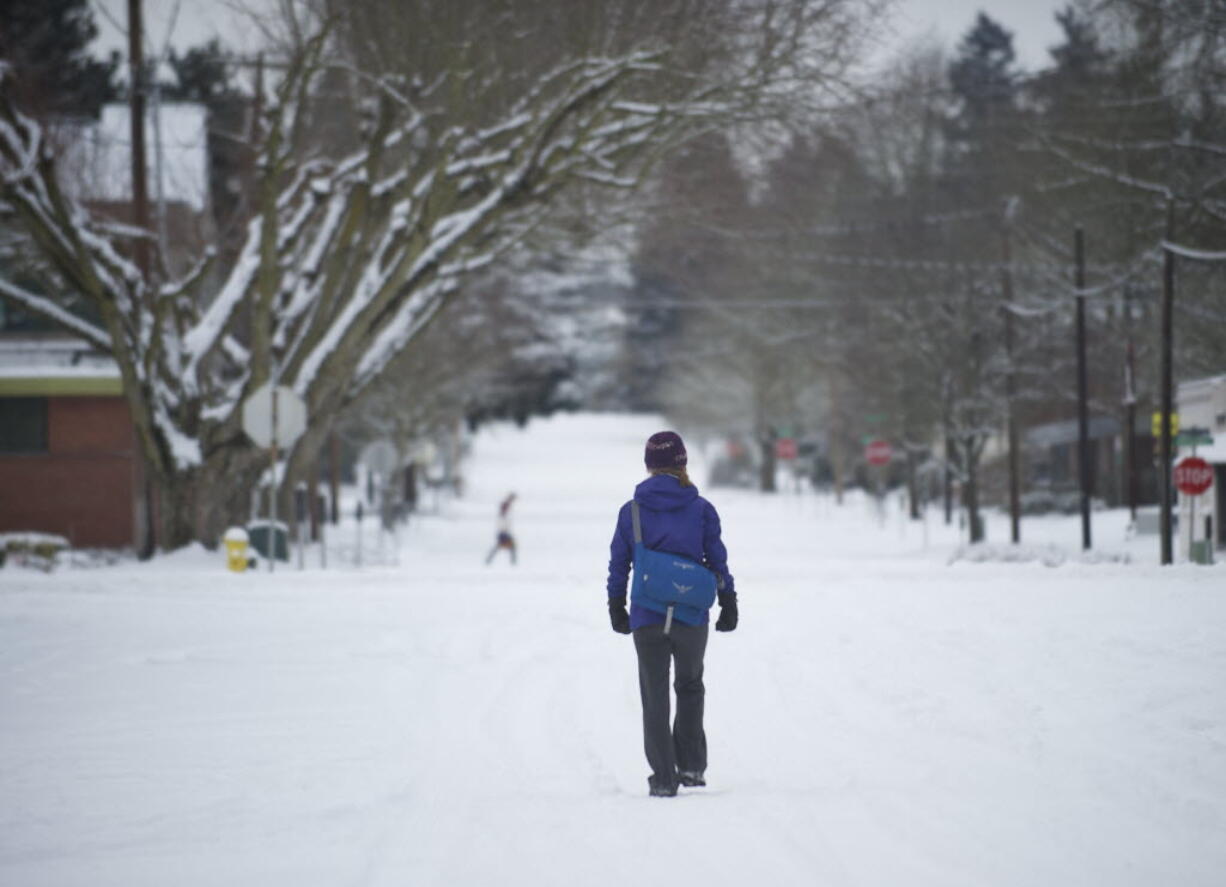 A woman walks down West 16th Street just west of Main Street in downtown Vancouver on Friday.