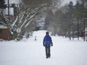 A woman walks down West 16th Street just west of Main Street in downtown Vancouver on Friday.