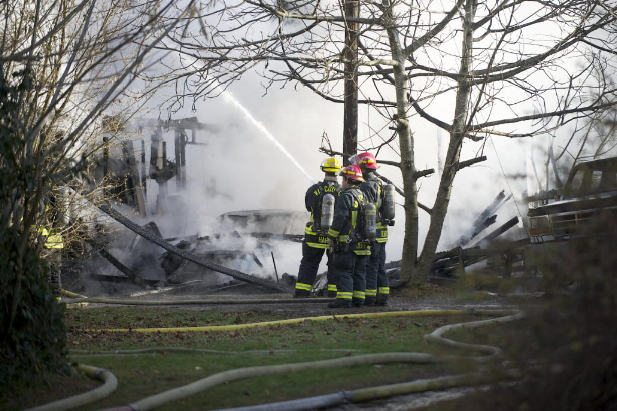 Vancouver firefighters work to control a fire at 4201 N.E. 59th Ave.