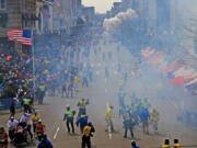 A plume of smoke rises from an explosion near the finish line of the 2013 Boston Marathon.