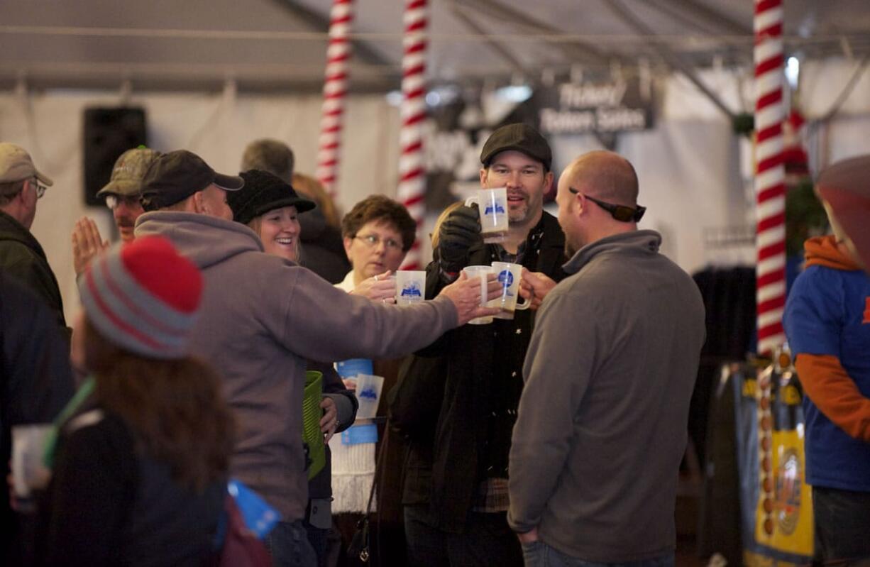 Terry Johnson, from left, Jennifer Hewett, David Hewett and Ryan Tofell, all from Vancouver, attend last year's Vancouver Winter Brewfest.