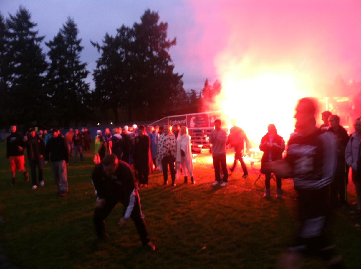 Clark College fans light flares as they celebrate the Penguins' victory over Spokane on Saturday.