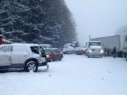 At least one person died and 15 vehicles were totaled Thursday morning during a pileup crash that closed Interstate 5 near Battle Ground as a snow storm descended on Clark County.