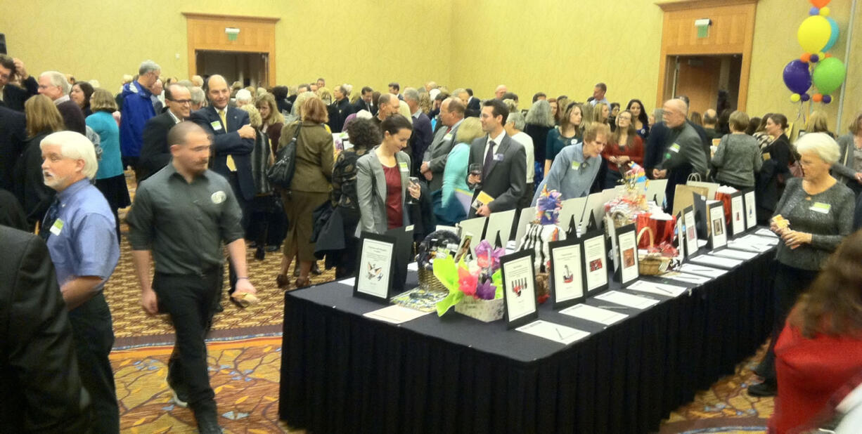 Library supporters browse items up for auction Thursday at the 2013 Authors &amp; Illustrators Dinner benefiting the Fort Vancouver Regional Library Foundation.