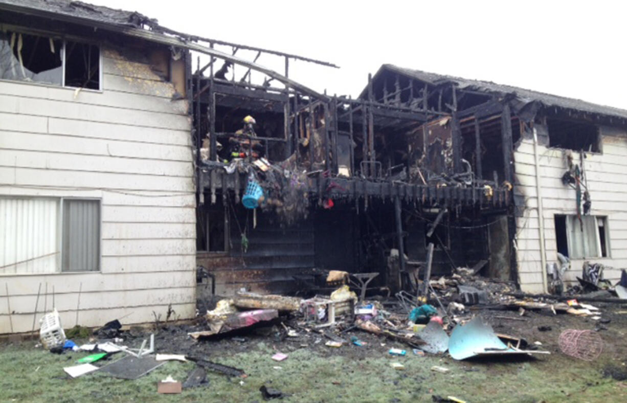 Fire crews clean up after a two-alarm apartment fire in the Ogden area damaged at least four units.