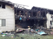 Fire crews clean up after a two-alarm apartment fire in the Ogden area damaged at least four units.