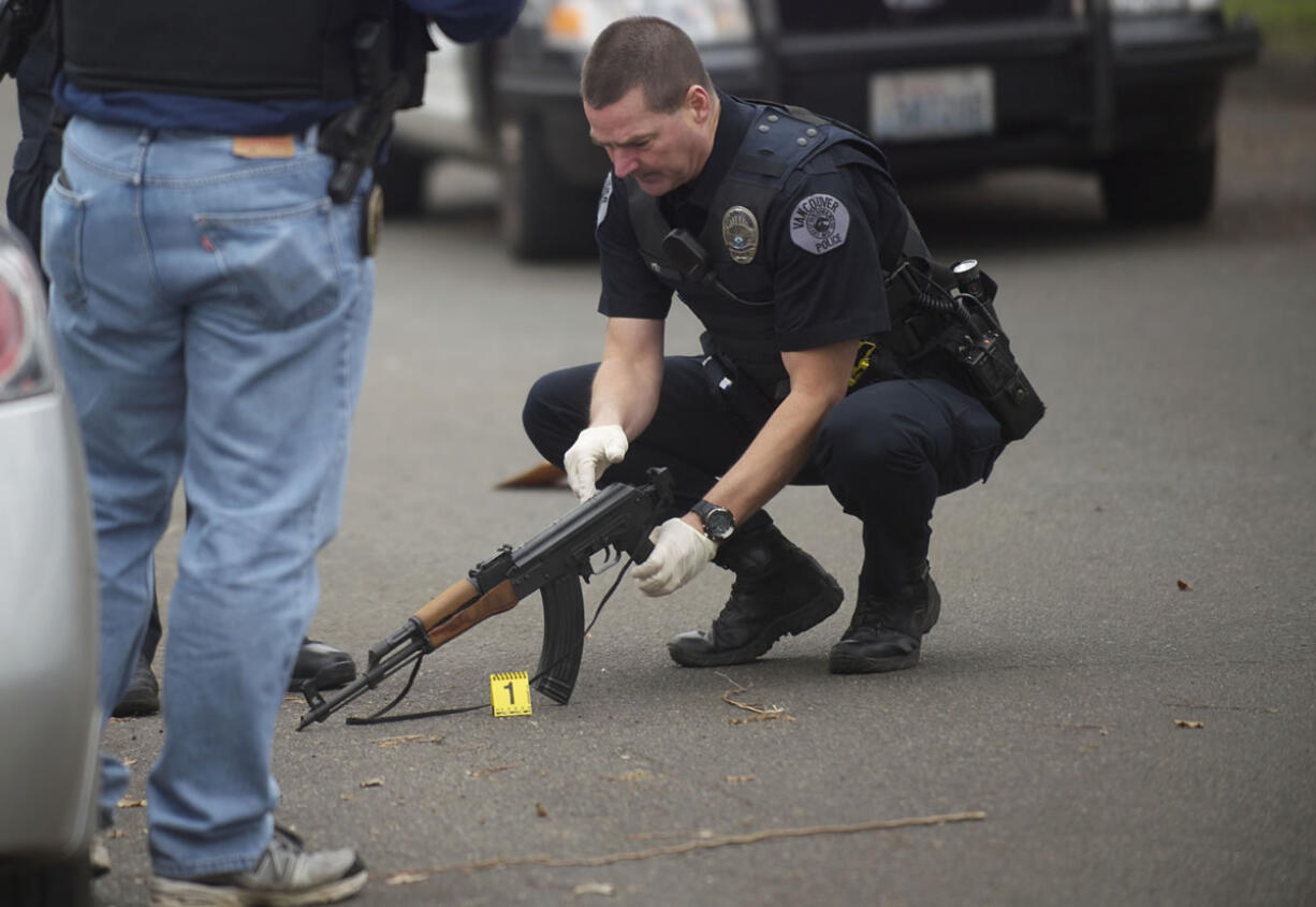 Vancouver Police investigate the scene where a man fired shot from an assault rifle on the 100 block of West 30th Street on Wednesday.