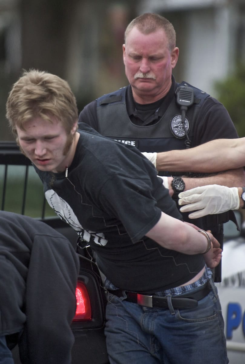 Vancouver Police take a man in to custody after he fired shots from an assault rifle on the 100 block of West 30th Street on Wednesday.