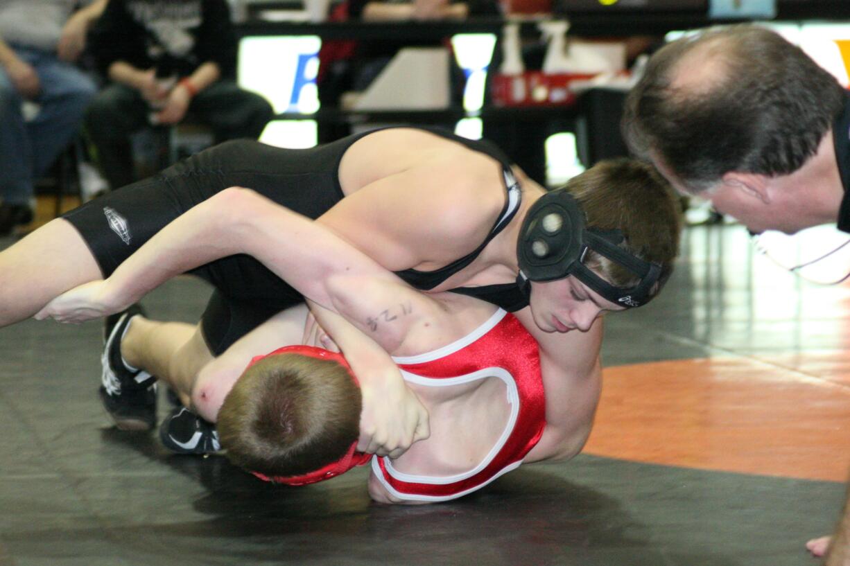 Washougal's Zach Oster turns Fort Vancouver's Isaiah Johnson on to his back and captures the 113-pound championship at the Washougal River Rumble Saturday.