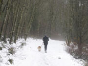 Caitlin Richardson and her dog Cowboy, jog the Lacamas Lake Heritage Trail, Saturday, December 27, 2008.