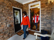 Elaine Adams and Lennar Homes representative Elaine Bridges exit the main entrance to a new &quot;Next Gen&quot; home in Apex, N.C., on Dec. 8.