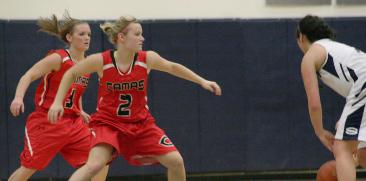 Camas High School seniors and twin sisters McKenna and Paige Jackson (left to right) like to keep their opponents second guessing on the basketball court.