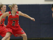 Camas High School seniors and twin sisters McKenna and Paige Jackson (left to right) like to keep their opponents second guessing on the basketball court.