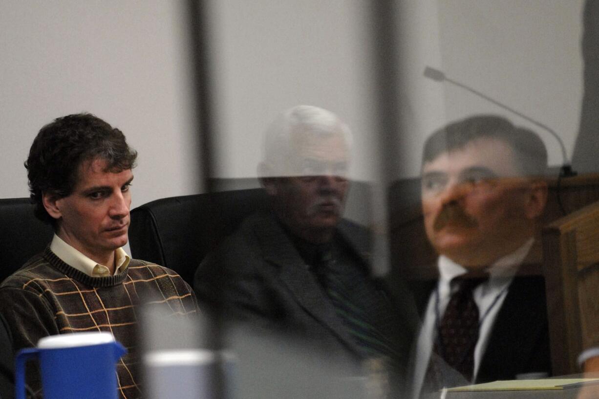 Joseph E. Duncan III, left, listens in the Kootenai County Sheriff's Department Justice building in Coeur d'Alene, Idaho, on Oct.