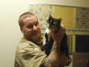 Photo courtesy of Larch Corrections Center
James Resop, an inmate at Larch Corrections Center, in Yacolt, is among the handlers in a cat adoption program. The effort, which started in 2012, involves volunteers training the offenders to care for the cats. After the cats are trained and socialized, they are placed for adoption.