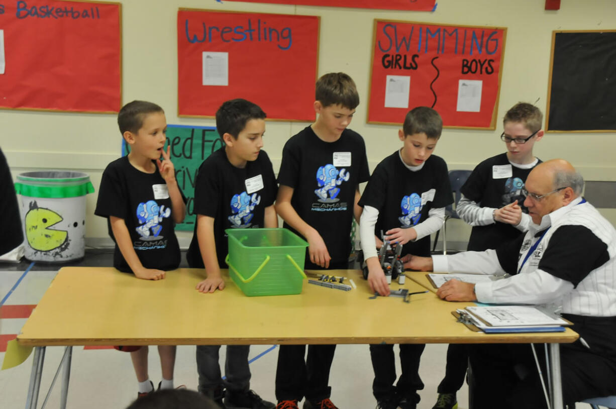 Before every FIRST LEGO League Robotics competition, a judge inspects the team's robot to ensure it meets requirements and asks questions. The Camas Mechanikids scored approximately 360 points, the highest of the contest.