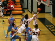 Washougal High School senior Aaron Deister splits the defense and scores a basket Thursday, at WHS. The Panthers defeated the Monarchs 66-58.