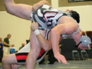 Camas High School senior Vince Huber throws Union's Cody Gromes to the mat during the 182-pound Clark County championship match Saturday, at Skyview High School. Huber held on for a 7-6 victory.