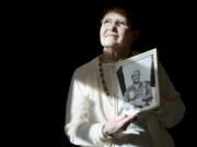 Gwen Hall Davis, the sister of missing Vancouver fighter pilot Harley Hall, holds a portrait of her brother.