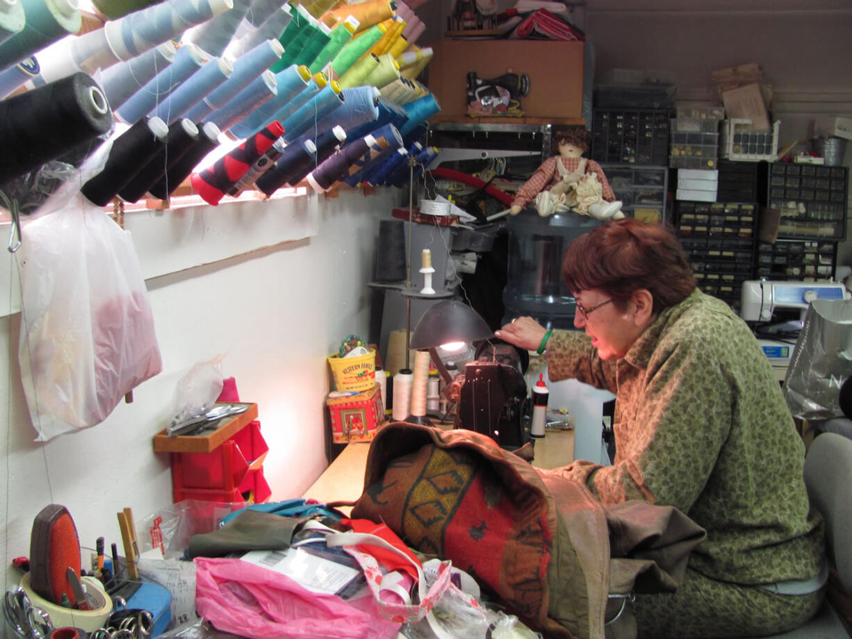 Karen Ferguson works on a jacket in her sewing room, at her Fern Prairie home. Ferguson, a seamstress, provides alterations and custom tailoring and sewing services. She also makes cushions, curtains and pillows. &quot;People bring projects to me,&quot; Ferguson said.