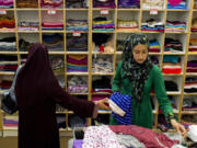 Mahum Tahir, 14, picks out scarves with her mom Fouzia Tahir, 42, at Al-Anwar in Anaheim, California, on Sept. 15.