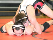 Tye Lommasson locks the arms of Evergreen's Jordan Moore and grinds his face into the mat, at Camas High School.