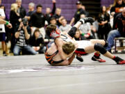 Camas' Austin Miller turns the tables on Battle Ground's Sean Trenda during the 132-pound 4A regional championship match Saturday, at Heritage High School.