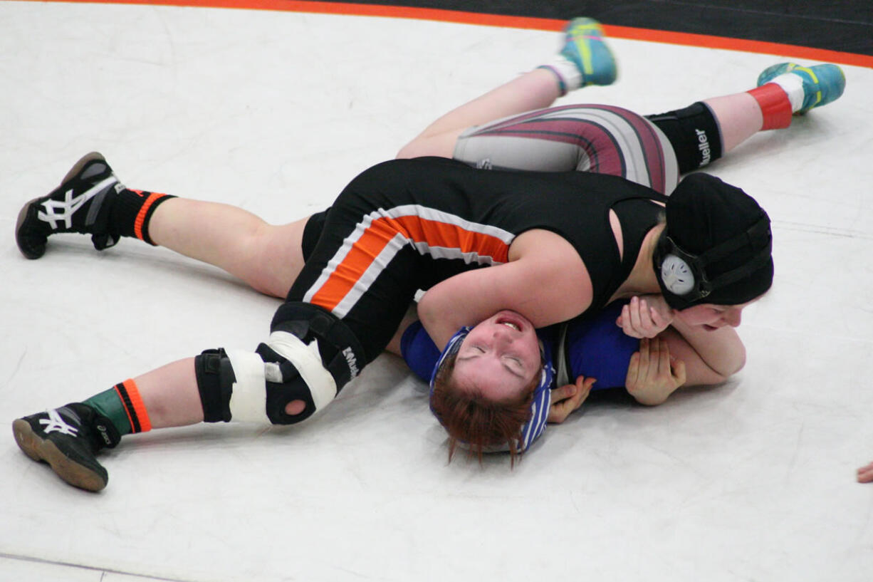 Washougal's Erin Locke pins Montesano's Rebecca Odegard for the girls regional 130-pound championship medal Saturday, at Battle Ground High School.