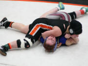 Washougal's Erin Locke pins Montesano's Rebecca Odegard for the girls regional 130-pound championship medal Saturday, at Battle Ground High School.