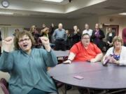 Leslie Morrison, left, a Vancouver Public Schools special education teacher with the GATE Program, reacts to election results, along with other teachers and board members, Tuesday evening.