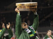 Portland Timbers forward Ryan Johnson hoists his three log cuttings, one for each goal he scored, after Sunday's 3-3 preseason tie against San Jose at Jeld-Wen Field.