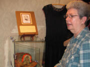 Volunteer Coordinator Lois Cobb points out a hat collection currently on display at the Two Rivers Heritage Museum.