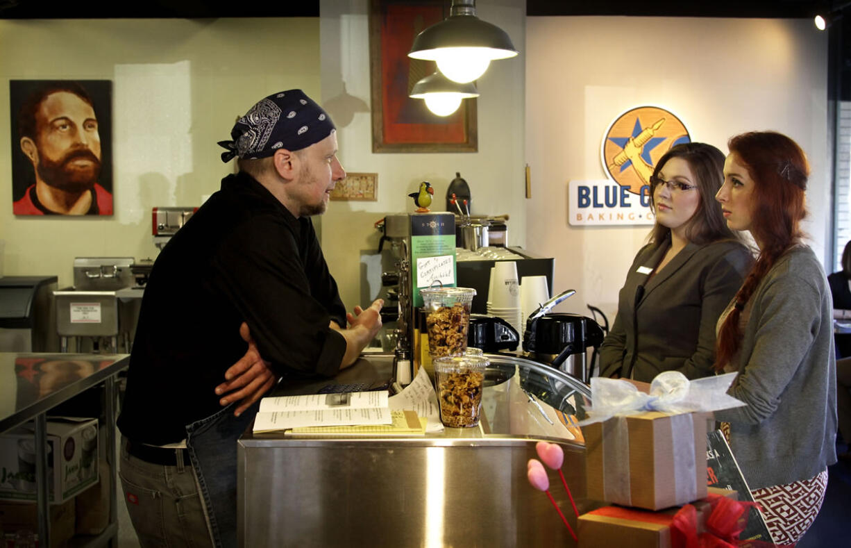 Owner Warren Becker, left, chats with customers Jan.