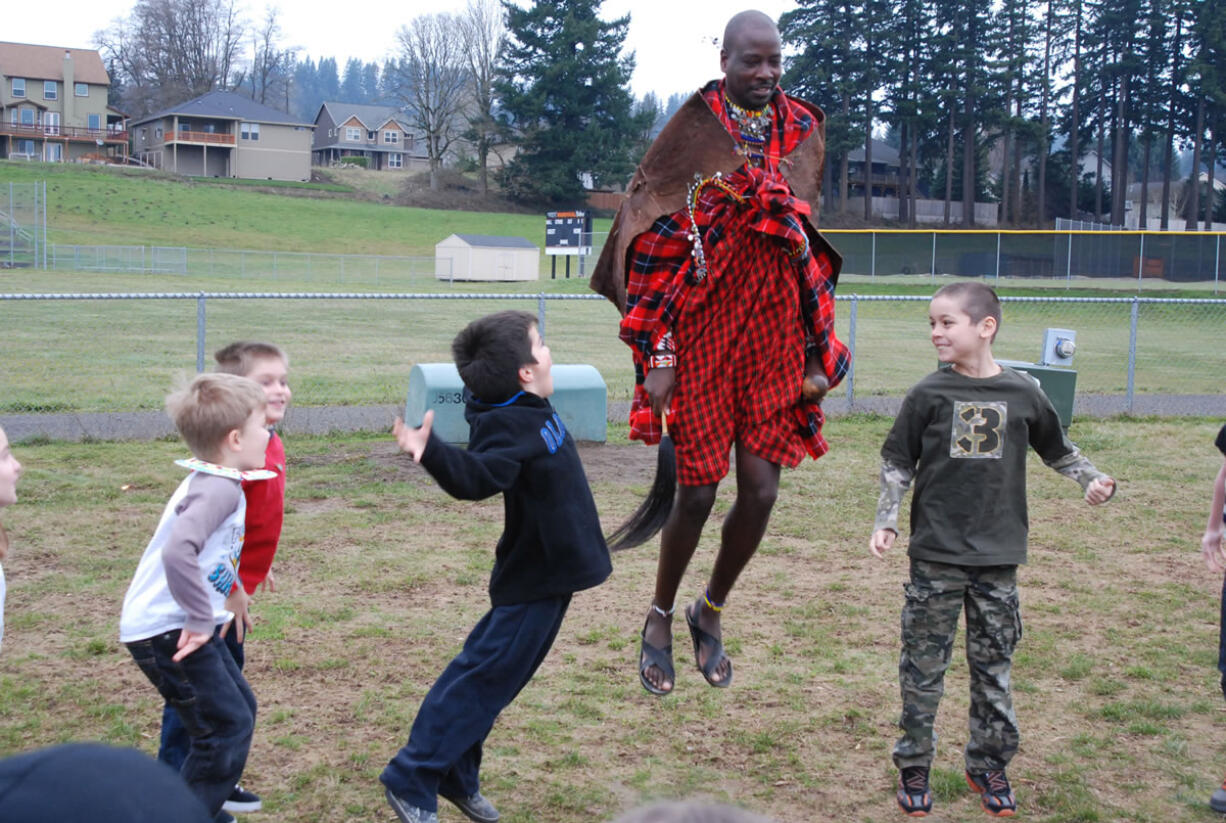 Sabore Ole Oyie, of Kenya, teaches Gause Elementary School second-graders a traditional dance that is typically performed following a successful lion hunt in the Ewaso Nyiro region.