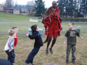 Sabore Ole Oyie, of Kenya, teaches Gause Elementary School second-graders a traditional dance that is typically performed following a successful lion hunt in the Ewaso Nyiro region.