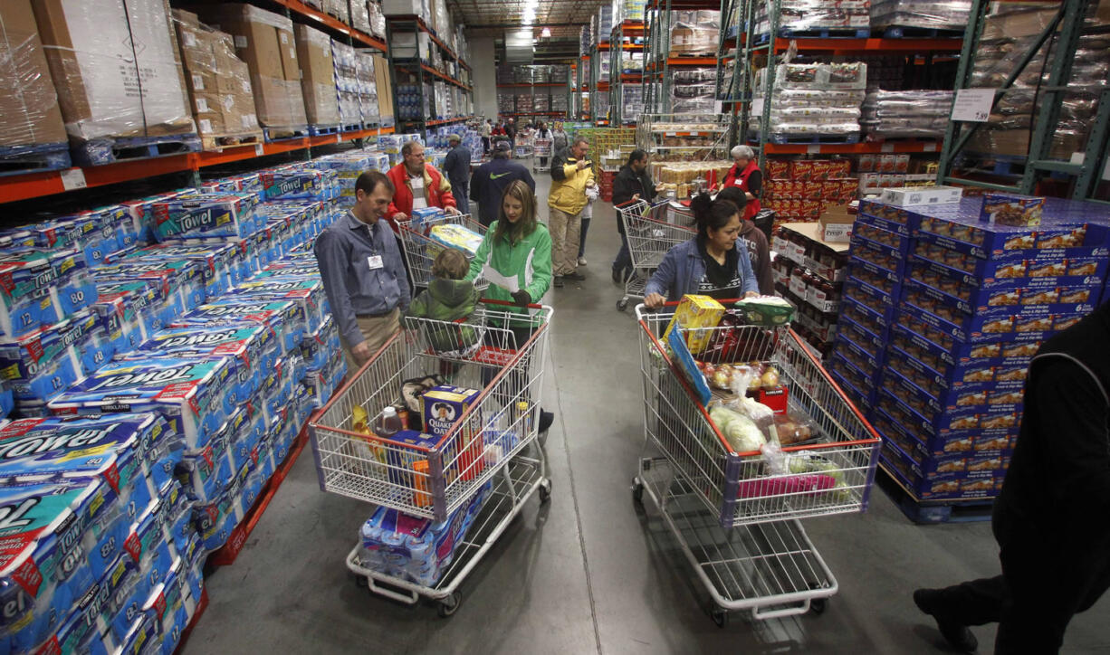 Customers shop at a Costco in Portland on Dec.