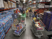 Customers shop at a Costco in Portland on Dec.