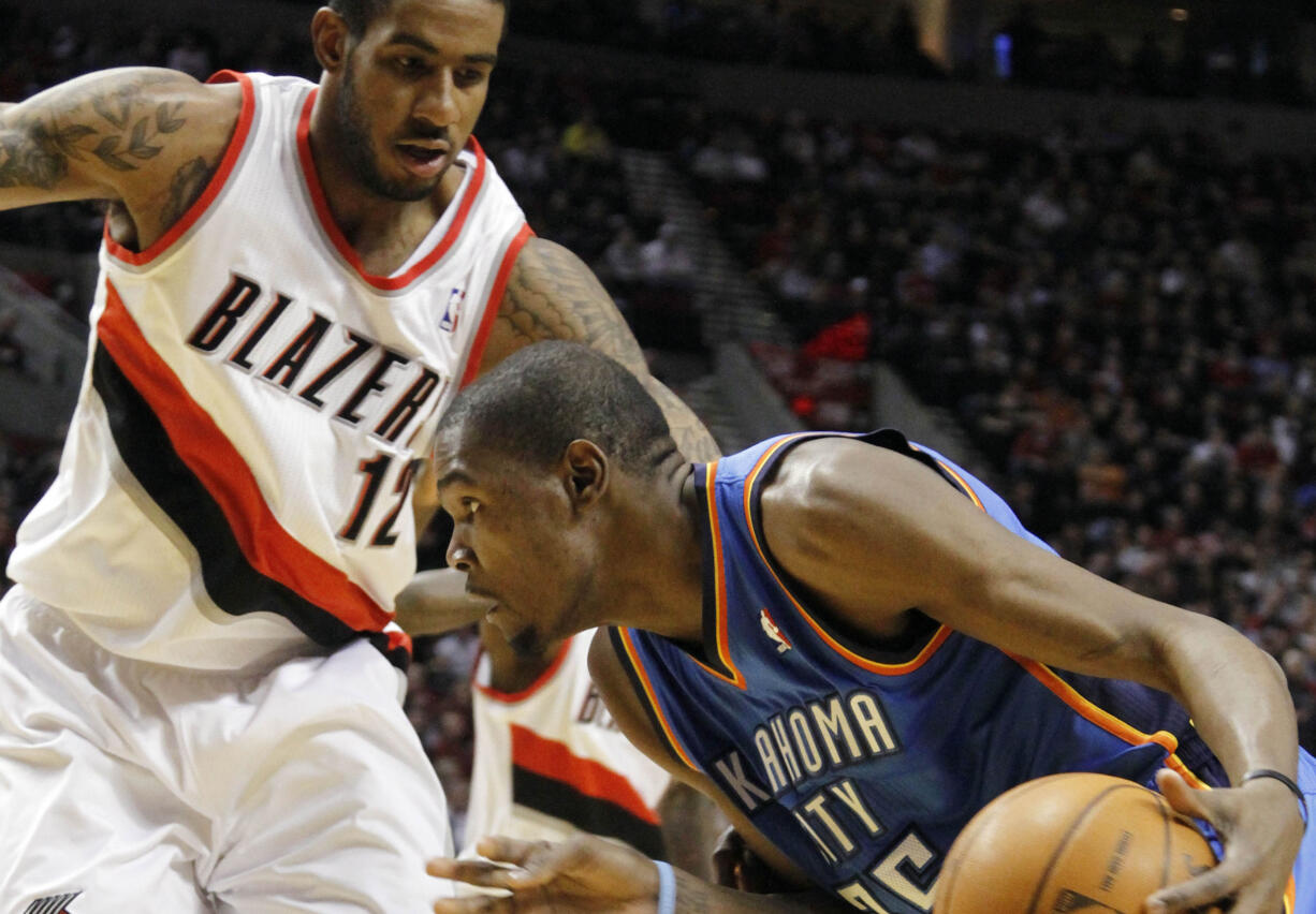 Oklahoma City Thunder forward Kevin Durant, right, drives on Porltand Trail Blazers forward LaMarcus Aldridge during the first half of their NBA basketball game in Portland, Ore., Monday, Feb.