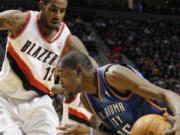 Oklahoma City Thunder forward Kevin Durant, right, drives on Porltand Trail Blazers forward LaMarcus Aldridge during the first half of their NBA basketball game in Portland, Ore., Monday, Feb.