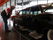 Mark McNeely checks out the 1964 Lincoln Continental limousine modified for Pope Paul VI's visit to New York City on display at the LeMay automobile museum in Tacoma.